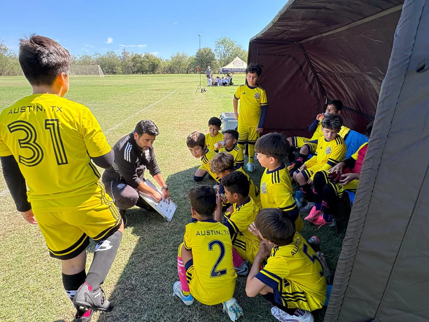 Coach explaining tactics to U11 players