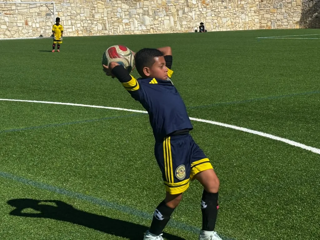 U11 player taking a throw-in